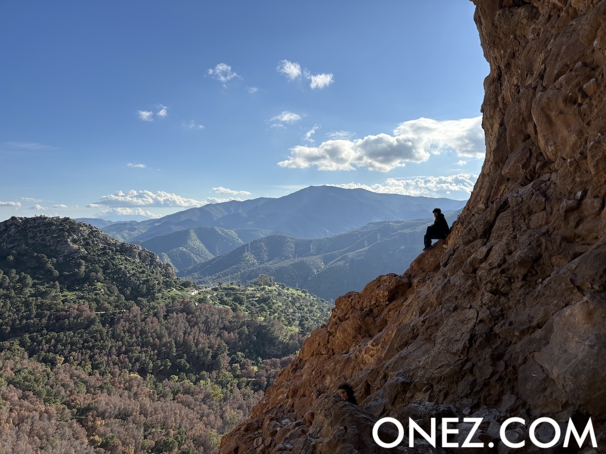 My son watching his friend climb, while enjoying the view of nature in a spectacular spot. The photo may seem like he’s sitting on the edge of a cliff, but there’s actually a big margin of safety.